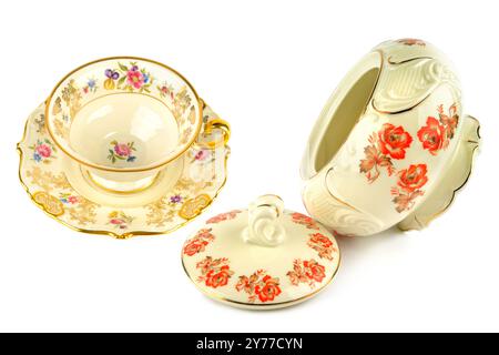 Vintage porcelain tableware: coffee cup with saucer and elegant candy bowl isolated on white background. Collage. Stock Photo