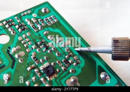 Failed solder joints on the broken electronic circuit board. Cold solder joint. Focused on soldered point. Stock Photo