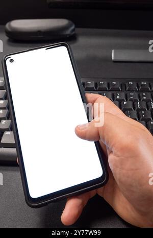 Hand holding smartphone with blank screen isolated Stock Photo