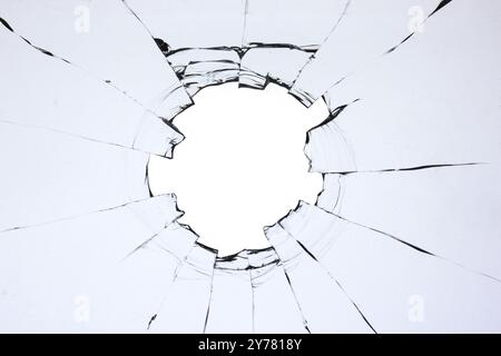 Hole in the glass, broken window with cracks texture. Effect of broken transparent glass Stock Photo