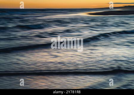 Serene ocean scene with soft colors and calming waters at dusk, abstract ocean Stock Photo