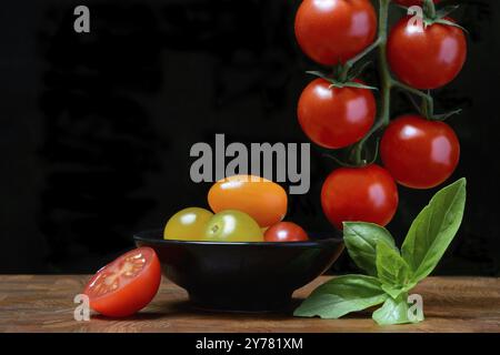 Cherry tomatoes on the stem and in skin, cherry tomato Stock Photo