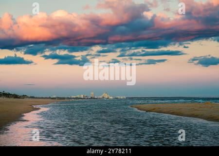 Peaceful shoreline scene with colorful skies and reflections on the water. Stock Photo