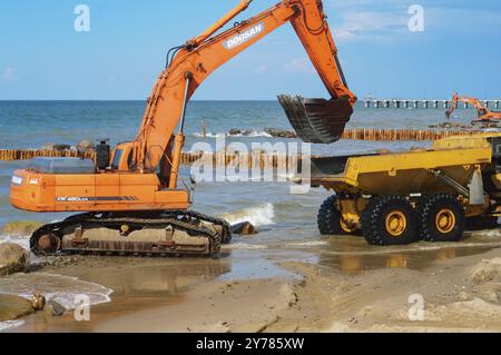 Construction of breakwaters, construction equipment on the sea coast, Baltic sea, Kaliningrad region, Russia, July 15, 2018, Europe Stock Photo