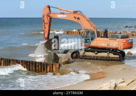 Construction of breakwaters, construction equipment on the sea coast, Baltic sea, Kaliningrad region, Russia, July 15, 2018, Europe Stock Photo