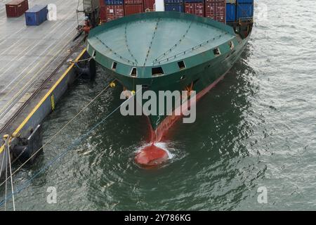 Green container vessel with completely covered of forward mooring station moored in Kingston, Jamaica. Stock Photo