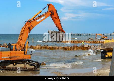 Construction of breakwaters, construction equipment on the sea coast, Baltic sea, Kaliningrad region, Russia, July 15, 2018, Europe Stock Photo
