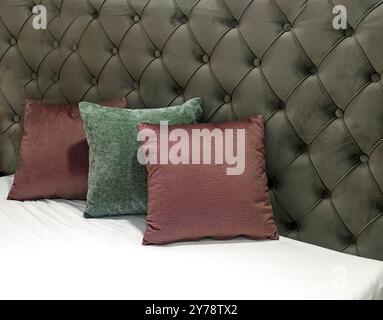 Colorful decorative pillows on empty bed inside modern interior Stock Photo