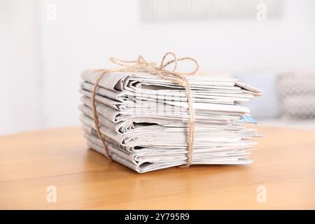Stack of many newspapers on wooden table Stock Photo