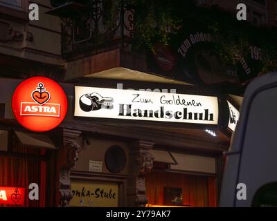 Zum Goldenen Handschuh (The Golden Glove) pub sign in the red-light  district of Hamburg. Illuminated logo with the boxing glove Stock Photo -  Alamy