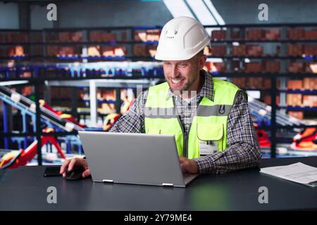 Man Staff In Parcel Delivery Center Using Computer Stock Photo