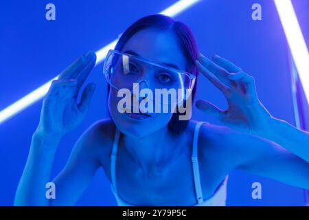 Concept of futuristic virtual reality technology or entertainment system. A woman lit up on the HUD interface Stock Photo