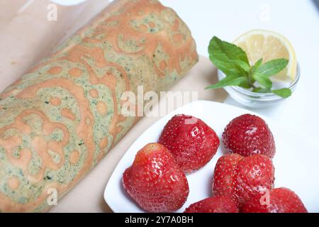 Preparation for making biscuit roll with spinach and mint. Stuffed with strawberries. Ingredients for cooking. Stock Photo
