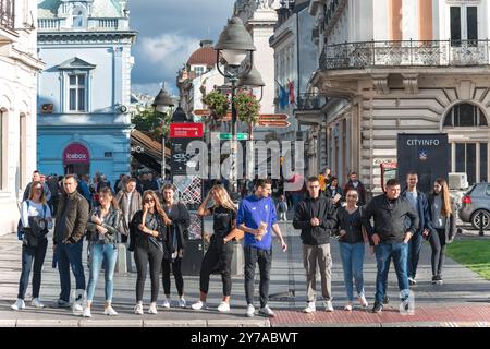 Belgrade, Serbia - September 13, 2019: Group of young tourists are waiting to cross a busy street in a city of Belgrade Stock Photo