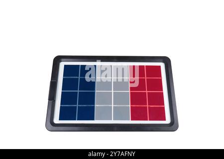 Portable solar panel in shape of flag of France on white background (close-up). Concept of developing renewable green alternative energy in France Stock Photo