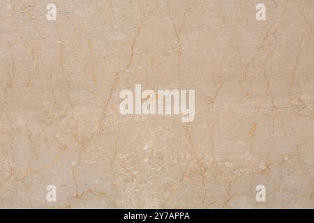 Elegant beige marble texture featuring fine veins, great for architectural projects. Stock Photo