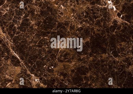 Polished brown marble with intricate veins, perfect for sophisticated interiors. Stock Photo