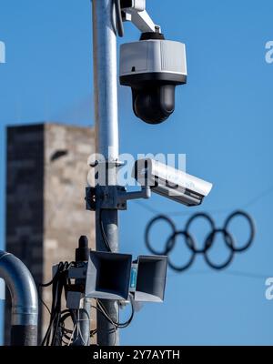 29 September 2024, Berlin: Video cameras are installed next to the stadium entrance at Coubertinplatz (south gate). The Olympic rings can be seen in the background above the entrance on Olympic Square. Photo: Soeren Stache/dpa Stock Photo