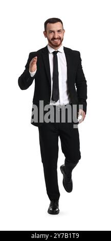 Young businessman in suit running on white background Stock Photo