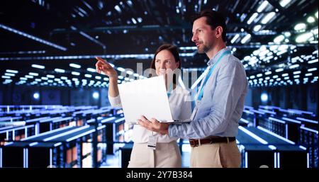 Server Room In Data Center. Cloud Computer Engineers Configuring AI Technology Stock Photo