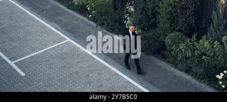 Top view of mature man in full suit walking outdoors Stock Photo