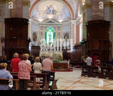 Congregation with altar and priest inside the Basilica di Santa Margherita aka Montefiascone Cathedral, Lazio region, Italy. September 28/29 2024 Stock Photo