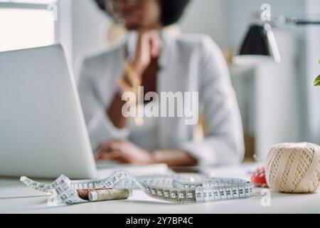Close-up of young African woman using laptop while working in design studio Stock Photo