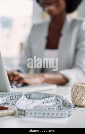 Close-up of young African woman using laptop while working in design studio Stock Photo