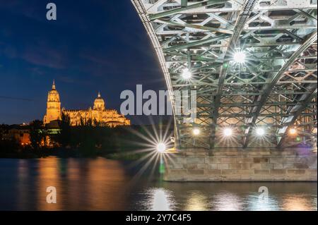 Night view of the cathedral of Salamanca (Spain) from under the Enrique Estevan bridge on the Tormes river Stock Photo