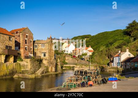 Staithes, North Yorkshire, UK - Old fishing village of Staithes, at high tide on a summer morning. Stock Photo