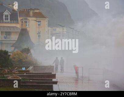 Teignmouth, Devon, UK. 29th Sep, 2024. UK weather: Wind, rain and gigantic waves crash into Teignmouth, Devon. Pictured: figures shrouded in sea spray as waves hit the Teignmouth sea wall. Credit: nidpor/Alamy Live News Stock Photo