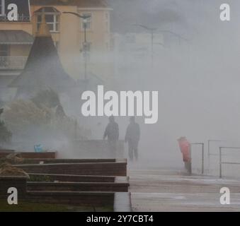 Teignmouth, Devon, UK. 29th Sep, 2024. UK weather: Wind, rain and gigantic waves crash into Teignmouth, Devon. Pictured: figures shrouded in sea spray as waves hit the Teignmouth sea wall. Credit: nidpor/Alamy Live News Stock Photo