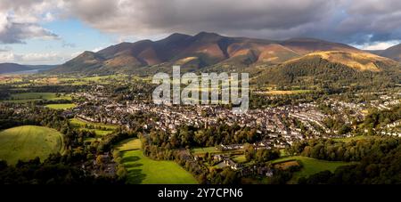 Aerial panoramic landscape of the Lake District town of Keswick on a beautiful Summer day with Bassenthwaite Lake and Skiddaw in The Northern Fells be Stock Photo