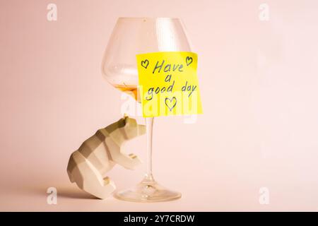 Positive message with wine glass and bear ornament on a cheerful note. Stock Photo
