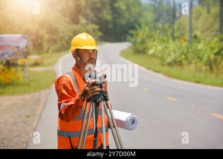 Road construction worker on job,Portrait of male engineer with hardhat using digital tablet while working at construction site,Highway engineer Stock Photo