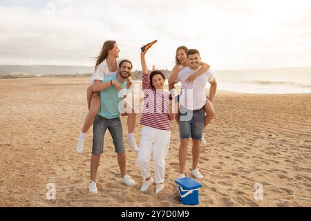 Joyful family beach day with laughter, games, and sunset on sandy shore Stock Photo