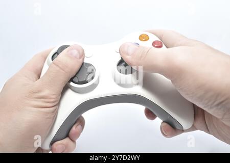 Joystick gamepad in the player's hands isolated on white background Stock Photo