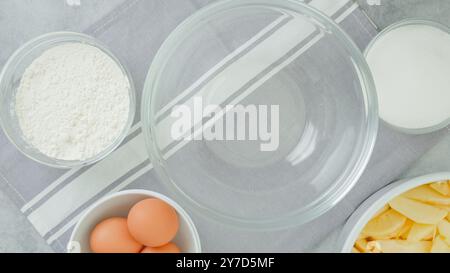 Apple cake recipe. Ingredients for baking needs close-up on a kitchen table, flat lay Stock Photo
