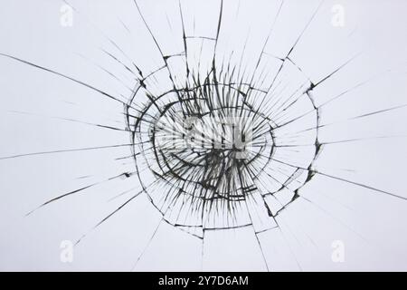 Broken glass texture on a white background. The protective glass of the phone is cracked from boredom. Cracks on damaged transparent material Stock Photo