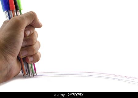 Multicolored pens in hand isolated on white background. Lines on white. Copy space Stock Photo