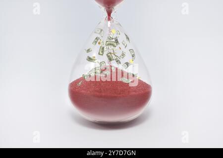 Hourglasses and coin isolated on white background. Time as money concept. money inside sandclock Stock Photo