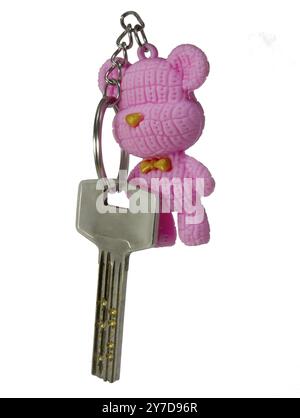 House keys with pink teddy bear isolated on white background Stock Photo
