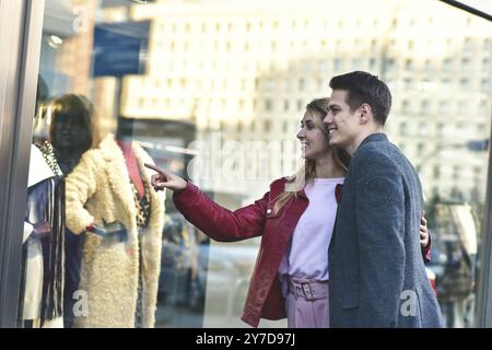 Beautiful young couple enjoying in shopping, having fun together. Consumerism, love, dating, lifestyle concept Stock Photo