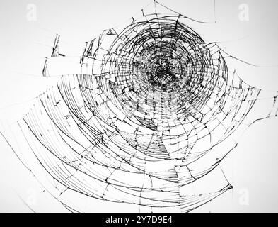 Cracked glass from impact, broken protective glass of the phone on a white background. Texture for design Stock Photo