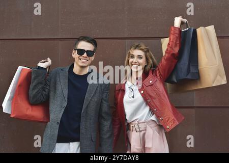 Beautiful young loving couple carrying shopping bags and enjoying together. Picture showing young couple shopping in the city Stock Photo