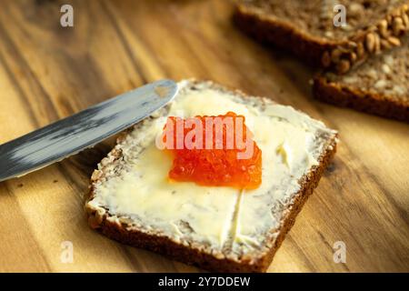 a sandwich of black bread, butter and red salmon caviar Stock Photo