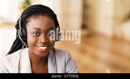 Portrait of friendly afro female customer service operator in headset Stock Photo
