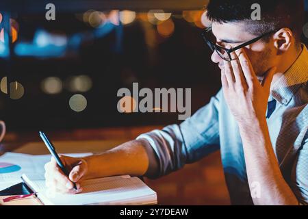 Man Touching Aching Eye Working In Dark Office Room Stock Photo