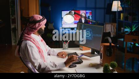 Trained arabic technician updating neural networks, writing intricate binary code scripts on computer. Middle Eastern man uses digital device programming to upgrade AI with TV as background noise Stock Photo