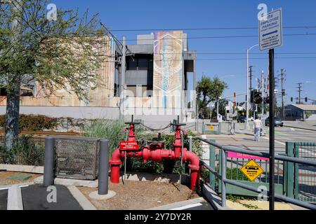 A detailed look at various backflow prevention valves and fire safety systems installed around an industrial site. Stock Photo